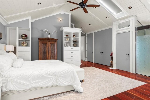 bedroom with lofted ceiling with beams, wood ceiling, wood finished floors, and a ceiling fan