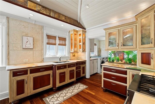 kitchen featuring dark wood-style flooring, decorative backsplash, light countertops, and a sink