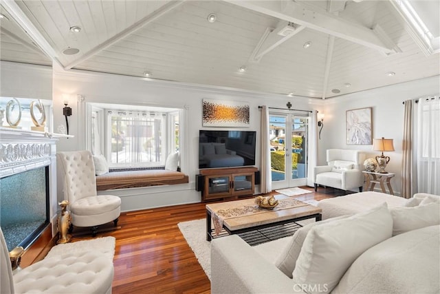 living area featuring wooden ceiling, vaulted ceiling with beams, wood finished floors, and a fireplace