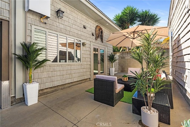 view of patio / terrace with an outdoor living space, french doors, and fence