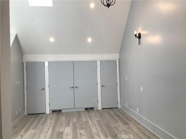 additional living space with baseboards, recessed lighting, wood finished floors, and lofted ceiling