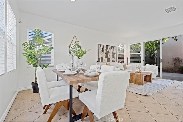 dining room with light tile patterned floors, baseboards, and visible vents