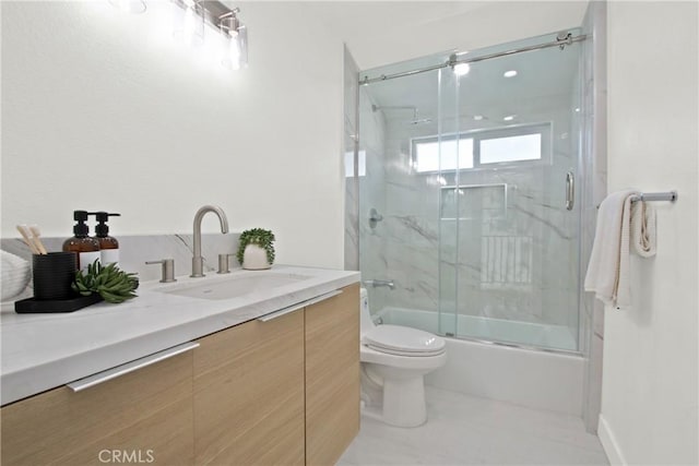 full bath with shower / bath combination with glass door, vanity, toilet, and tile patterned floors