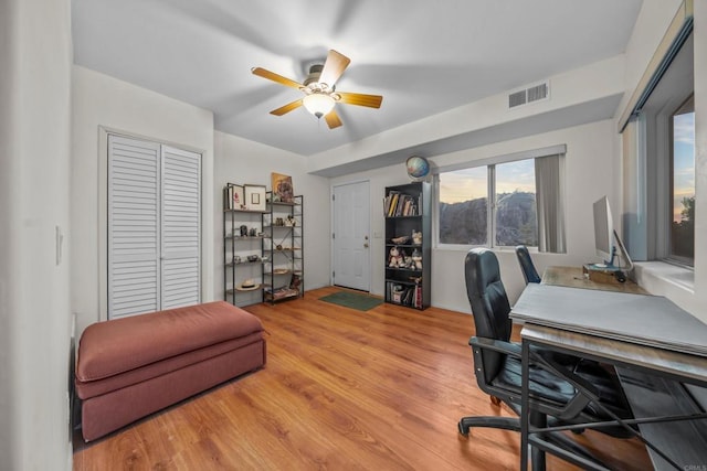 office with visible vents, wood finished floors, and a ceiling fan