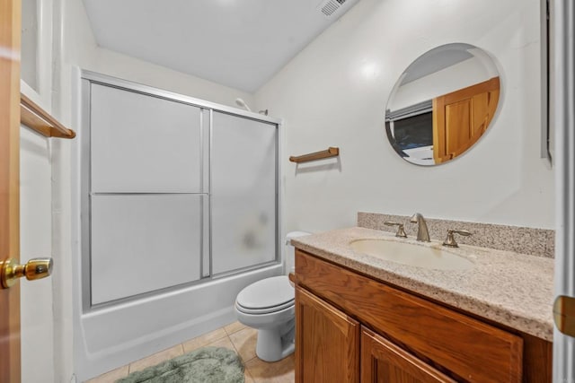 bathroom featuring tile patterned flooring, visible vents, toilet, combined bath / shower with glass door, and vanity