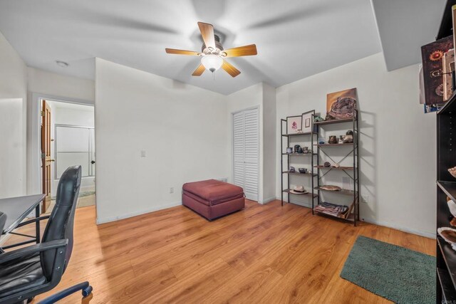 office featuring light wood-style floors, baseboards, and ceiling fan