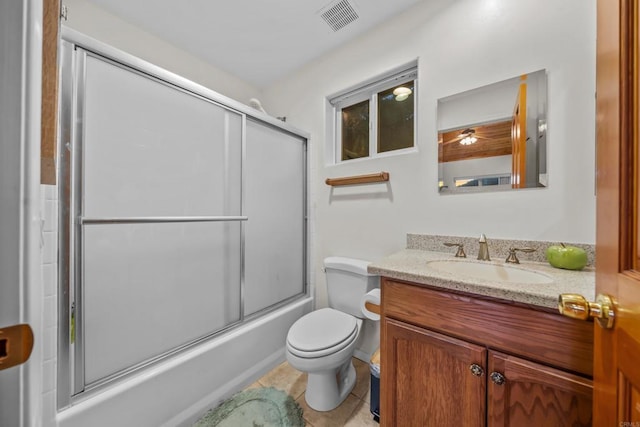 bathroom with tile patterned floors, visible vents, toilet, shower / bath combination with glass door, and vanity