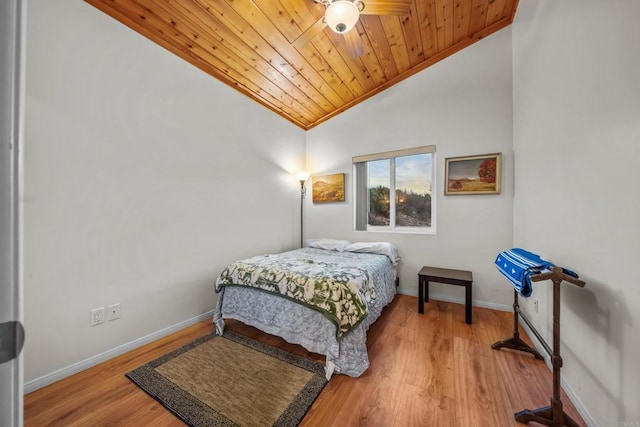 bedroom featuring baseboards, wood ceiling, wood finished floors, and vaulted ceiling