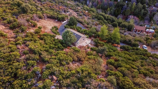 drone / aerial view with a wooded view