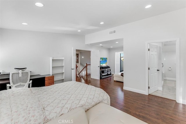 bedroom with recessed lighting, visible vents, vaulted ceiling, and wood finished floors