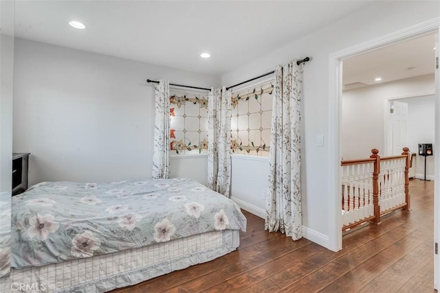 bedroom featuring hardwood / wood-style flooring, baseboards, and recessed lighting