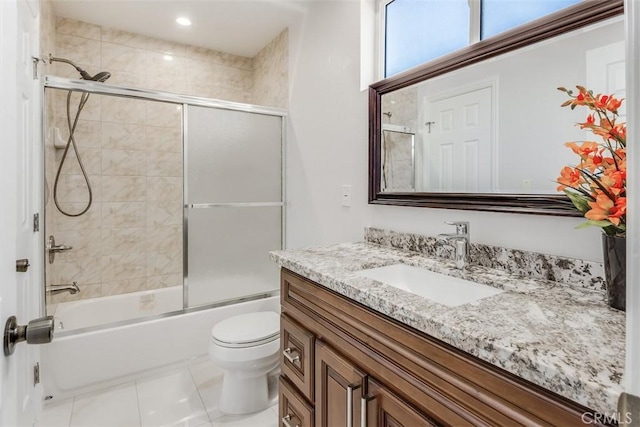 bathroom with toilet, tile patterned floors, enclosed tub / shower combo, and vanity