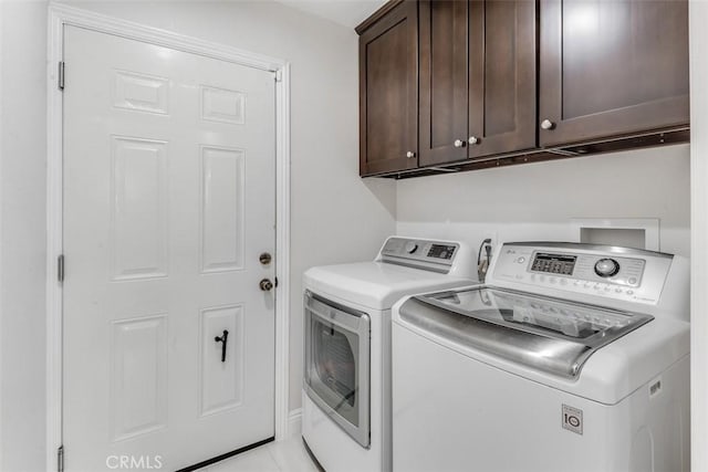 washroom with cabinet space and separate washer and dryer