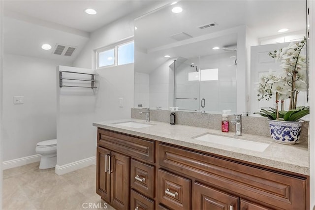 bathroom featuring double vanity, a shower stall, visible vents, and a sink