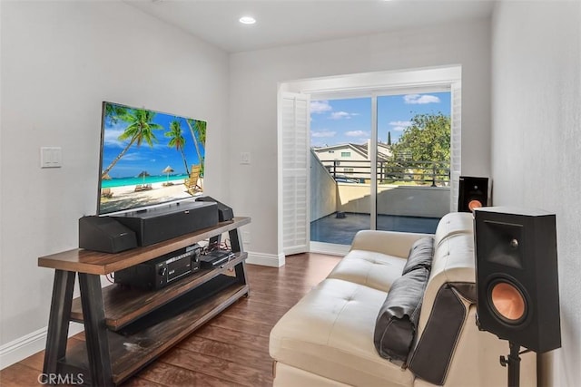 living area featuring baseboards, wood finished floors, and recessed lighting