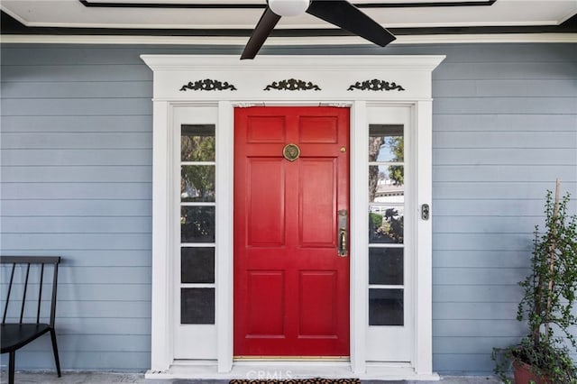 view of exterior entry featuring a ceiling fan