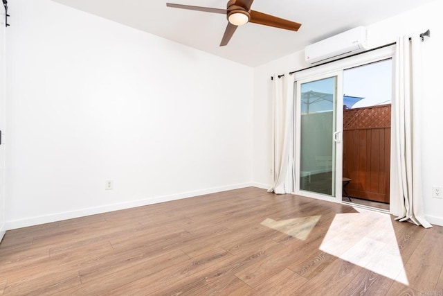 unfurnished room with light wood finished floors, baseboards, a ceiling fan, and a wall mounted air conditioner