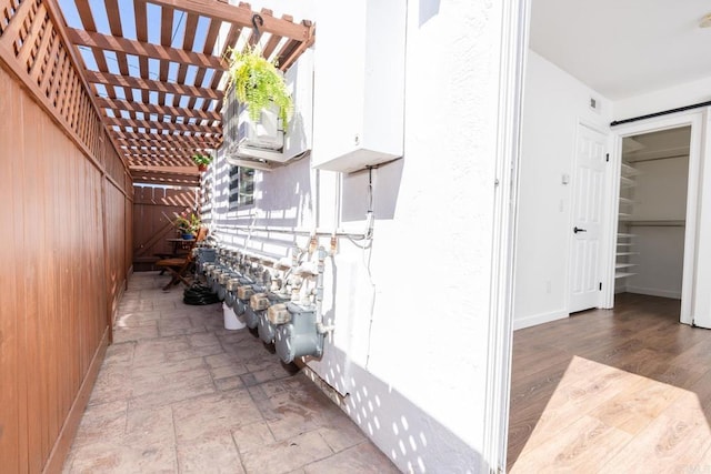 view of property exterior featuring stucco siding and a pergola