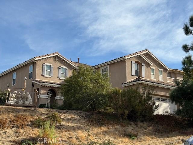 view of front of property with an attached garage and stucco siding