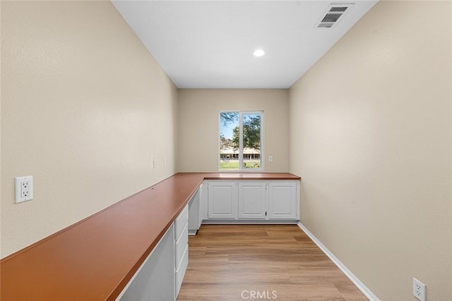 interior space featuring light wood-style floors, recessed lighting, visible vents, and baseboards