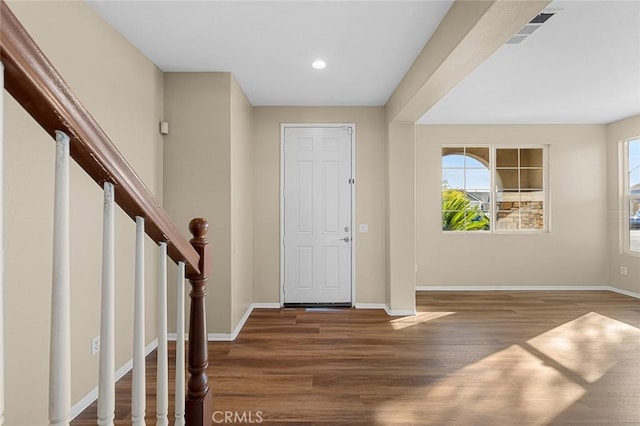 foyer with recessed lighting, wood finished floors, visible vents, baseboards, and stairs