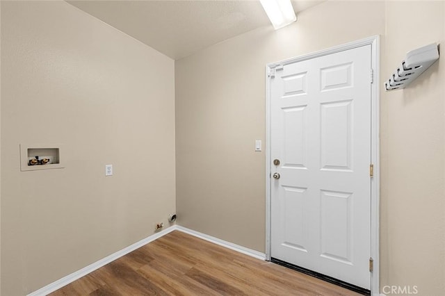 washroom with laundry area, wood finished floors, hookup for a washing machine, and baseboards