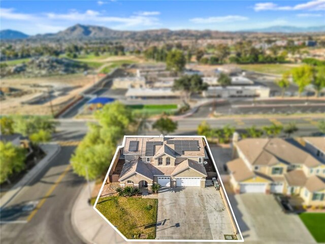 birds eye view of property with a mountain view