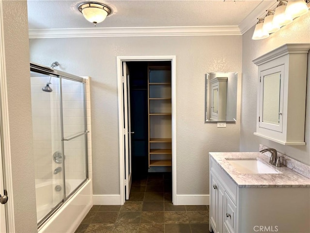 bathroom with enclosed tub / shower combo, crown molding, vanity, and baseboards