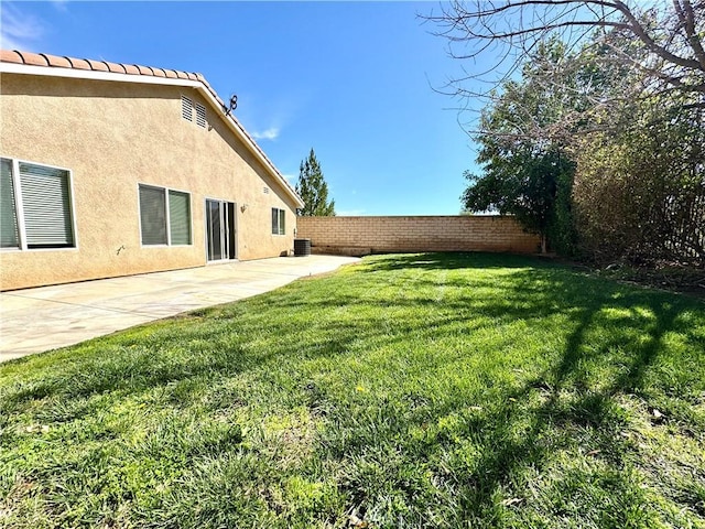 view of yard featuring a patio area, a fenced backyard, and central AC unit