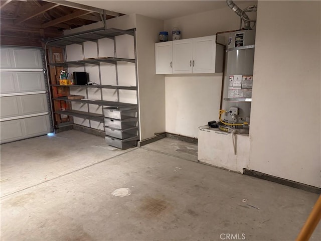 garage featuring water heater and baseboards