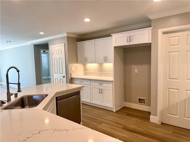 kitchen featuring wood finished floors, a sink, white cabinetry, ornamental molding, and stainless steel dishwasher