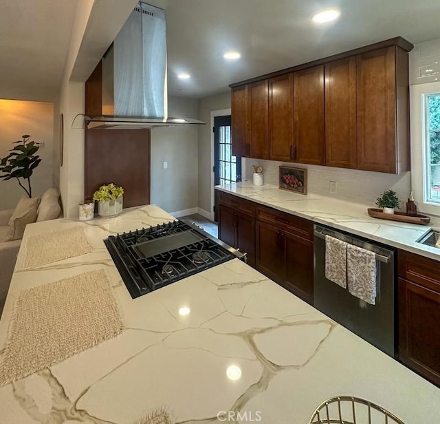 kitchen featuring exhaust hood, stainless steel dishwasher, backsplash, light stone countertops, and stovetop