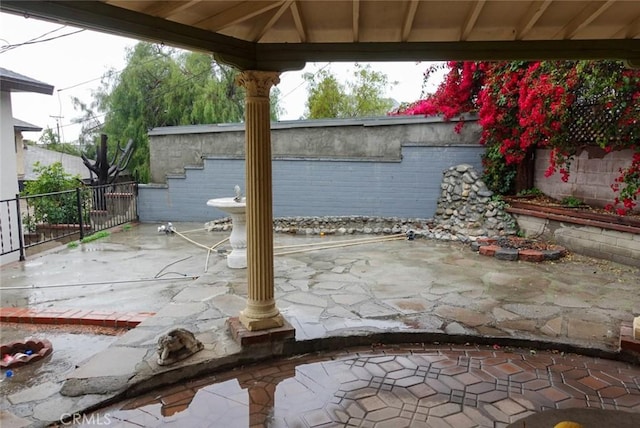 view of patio featuring fence and a gazebo