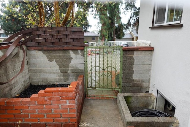 view of gate with fence