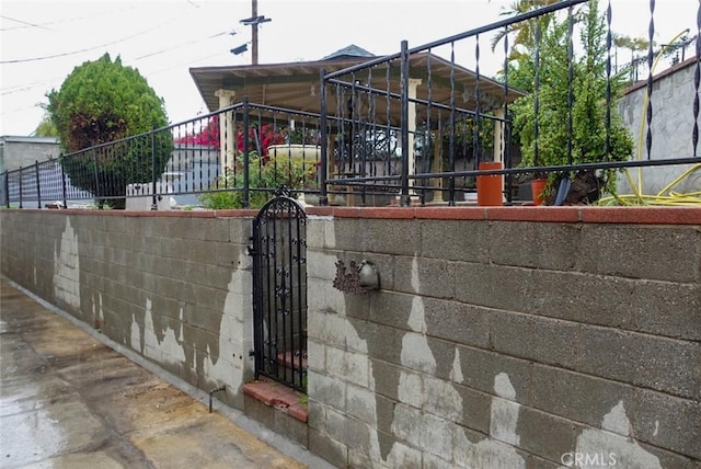 view of gate featuring fence