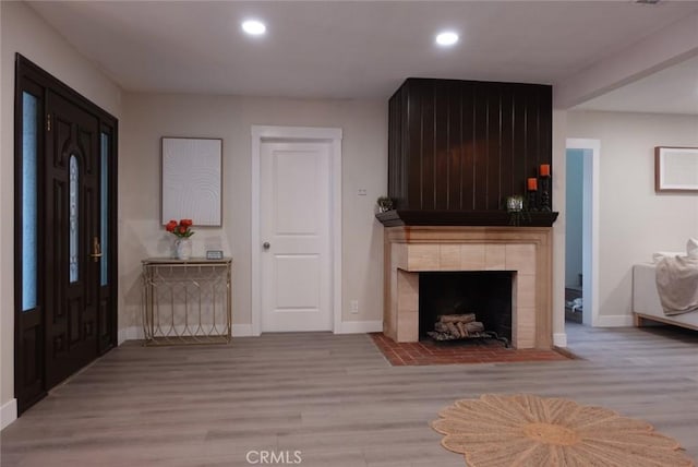 interior space featuring baseboards, wood finished floors, and recessed lighting