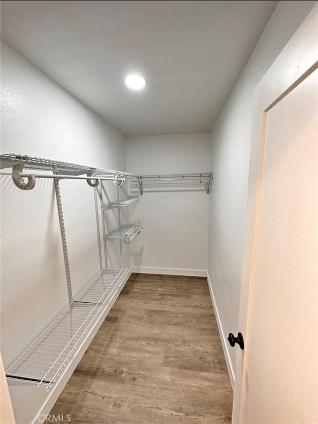 spacious closet with wood finished floors