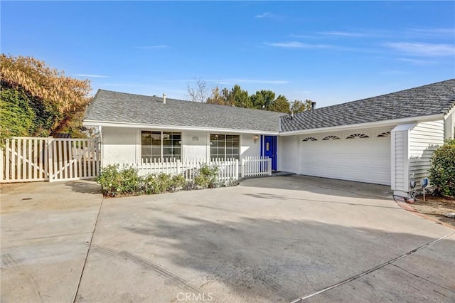 single story home featuring an attached garage, a shingled roof, concrete driveway, and stucco siding