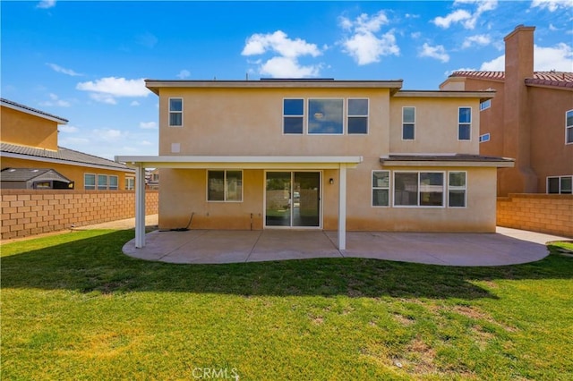 rear view of property featuring a patio area, fence, and stucco siding