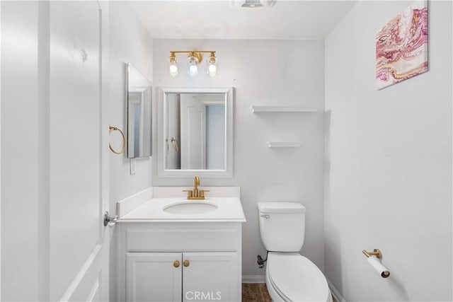 bathroom featuring toilet and vanity