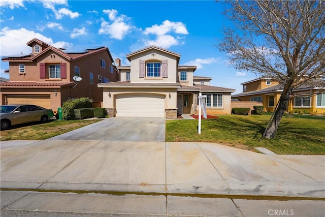 view of front facade with a garage, driveway, solar panels, a front lawn, and stucco siding