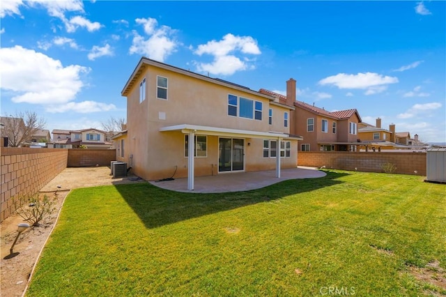 back of property featuring stucco siding, a lawn, a patio area, cooling unit, and a fenced backyard