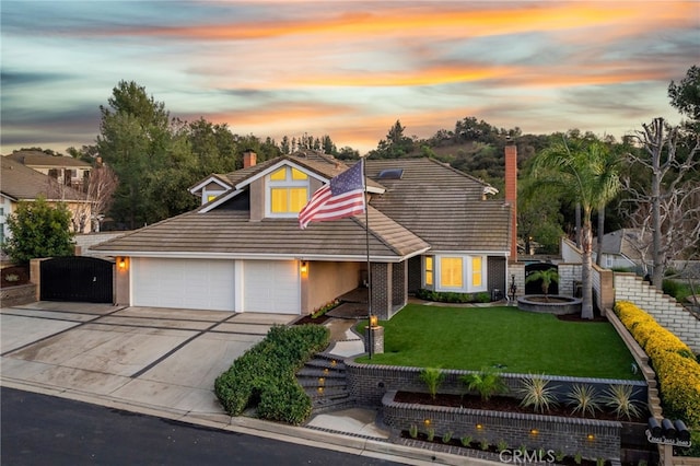 view of front of home featuring an attached garage, driveway, a lawn, stucco siding, and a chimney
