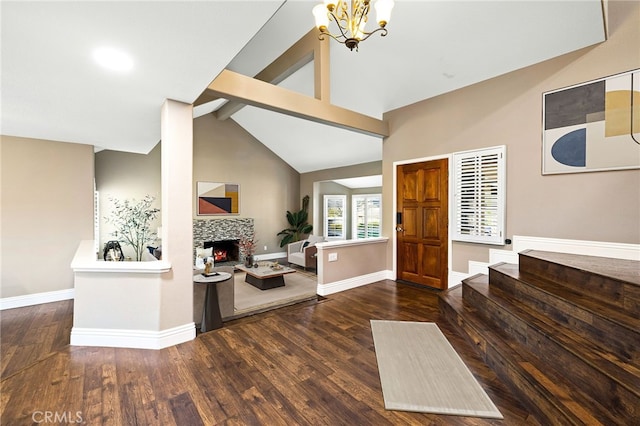 entryway featuring a lit fireplace, wood finished floors, beam ceiling, and baseboards