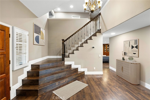 staircase with a chandelier, recessed lighting, a high ceiling, wood finished floors, and baseboards