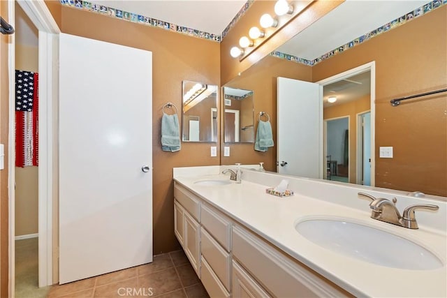 full bathroom featuring double vanity, a sink, and tile patterned floors