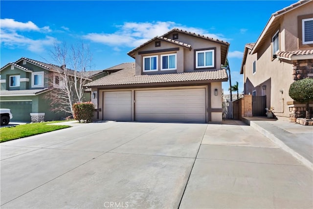 view of front of house with fence, a tile roof, concrete driveway, a gate, and stucco siding