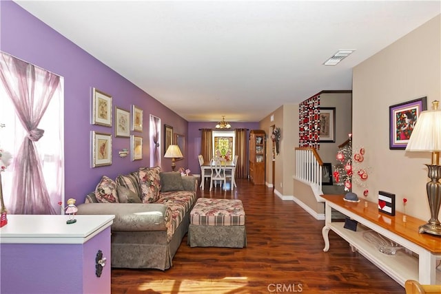 living room with baseboards, visible vents, stairway, wood finished floors, and an inviting chandelier