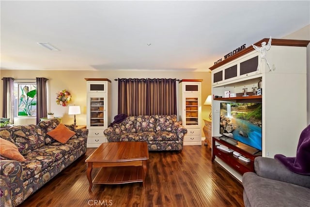 living area featuring wood finished floors and visible vents