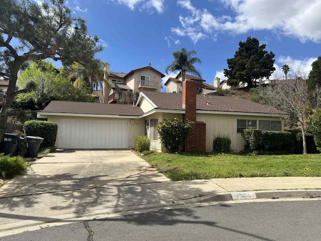 view of front of home with a garage, concrete driveway, a chimney, and a front yard